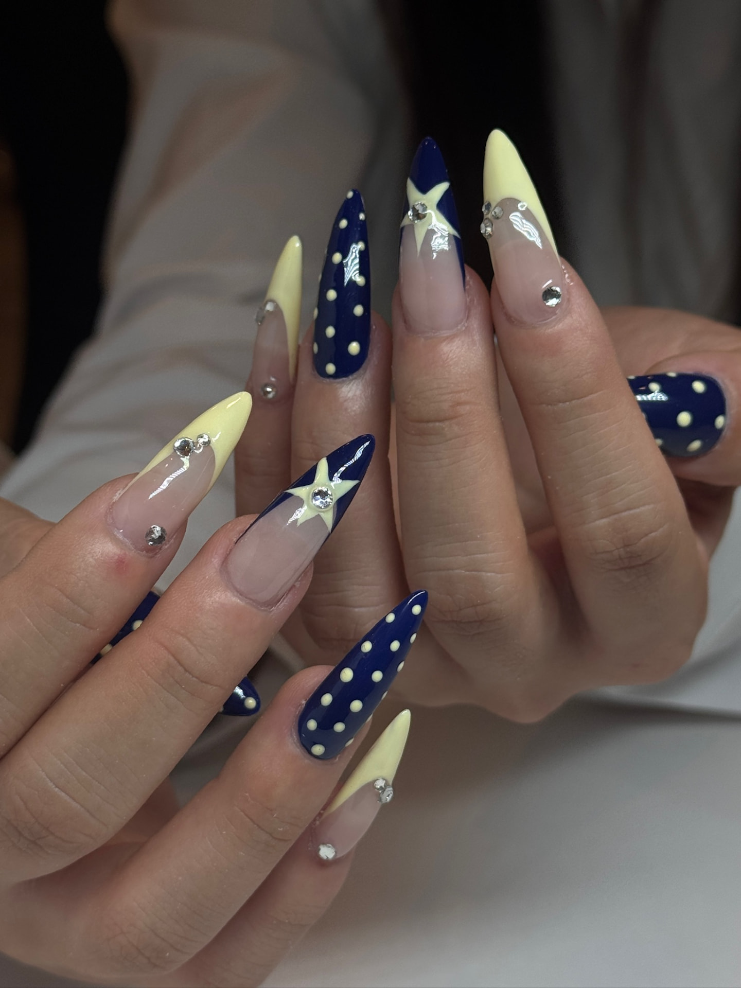 Blume Nail Bar - Luxury Nail Salon — long stiletto nails in midnight blue with cream stars, dots and gems