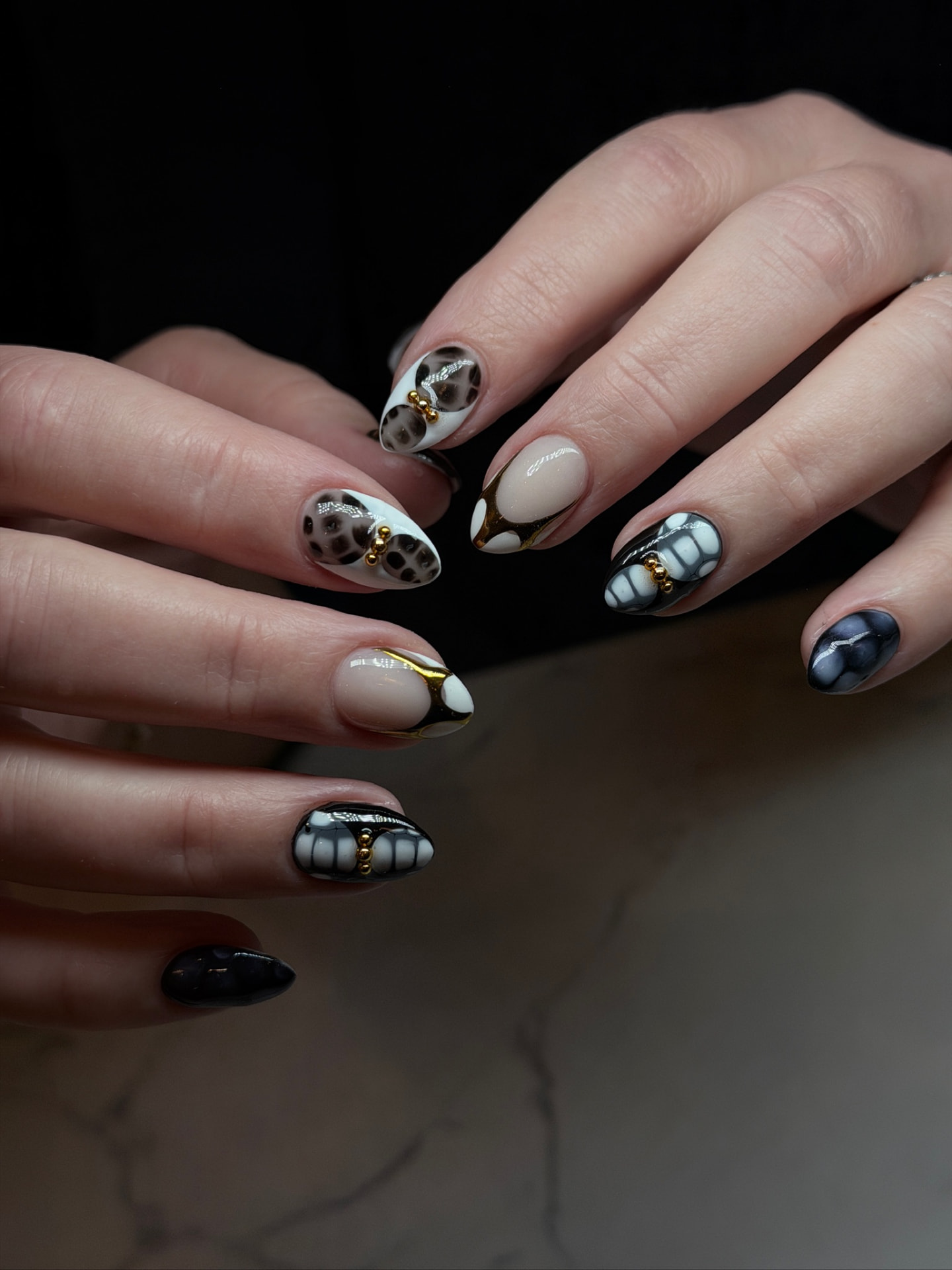 Blume Nail Bar - Luxury Nail Salon — tortoiseshell and black marble nails with gold accents