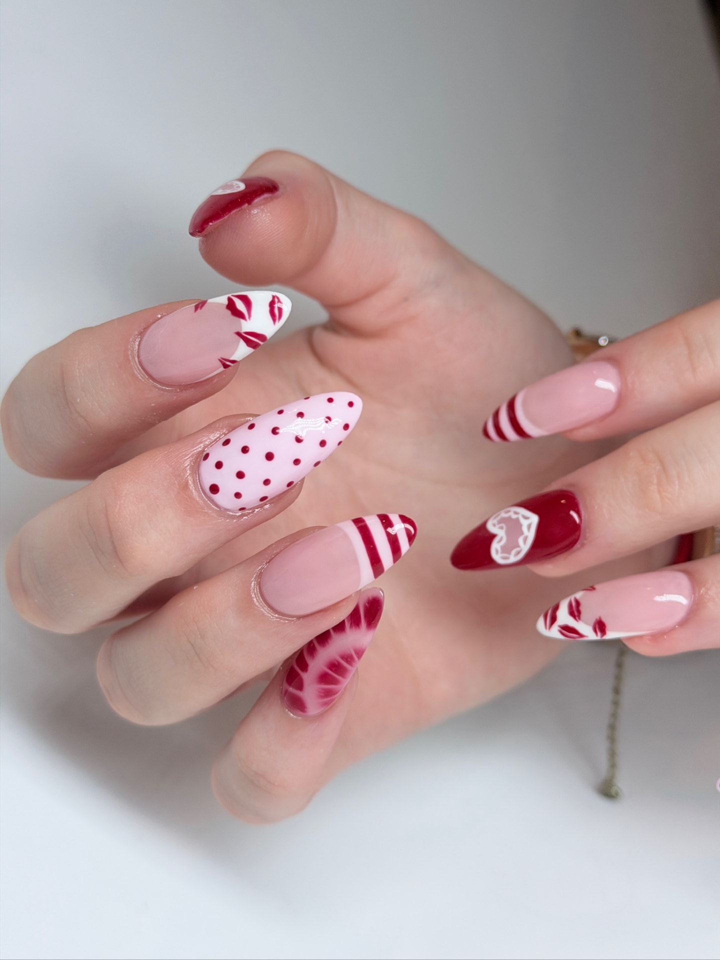 Blume Nail Bar - Luxury Nail Salon — almond nails with cherry-red lip motifs, polka dots and lace hearts