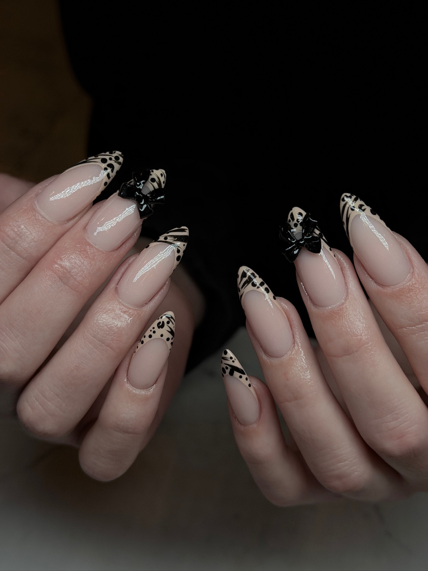 Blume Nail Bar - Luxury Nail Salon — nude almond nails with black leopard tips and glossy 3D bows