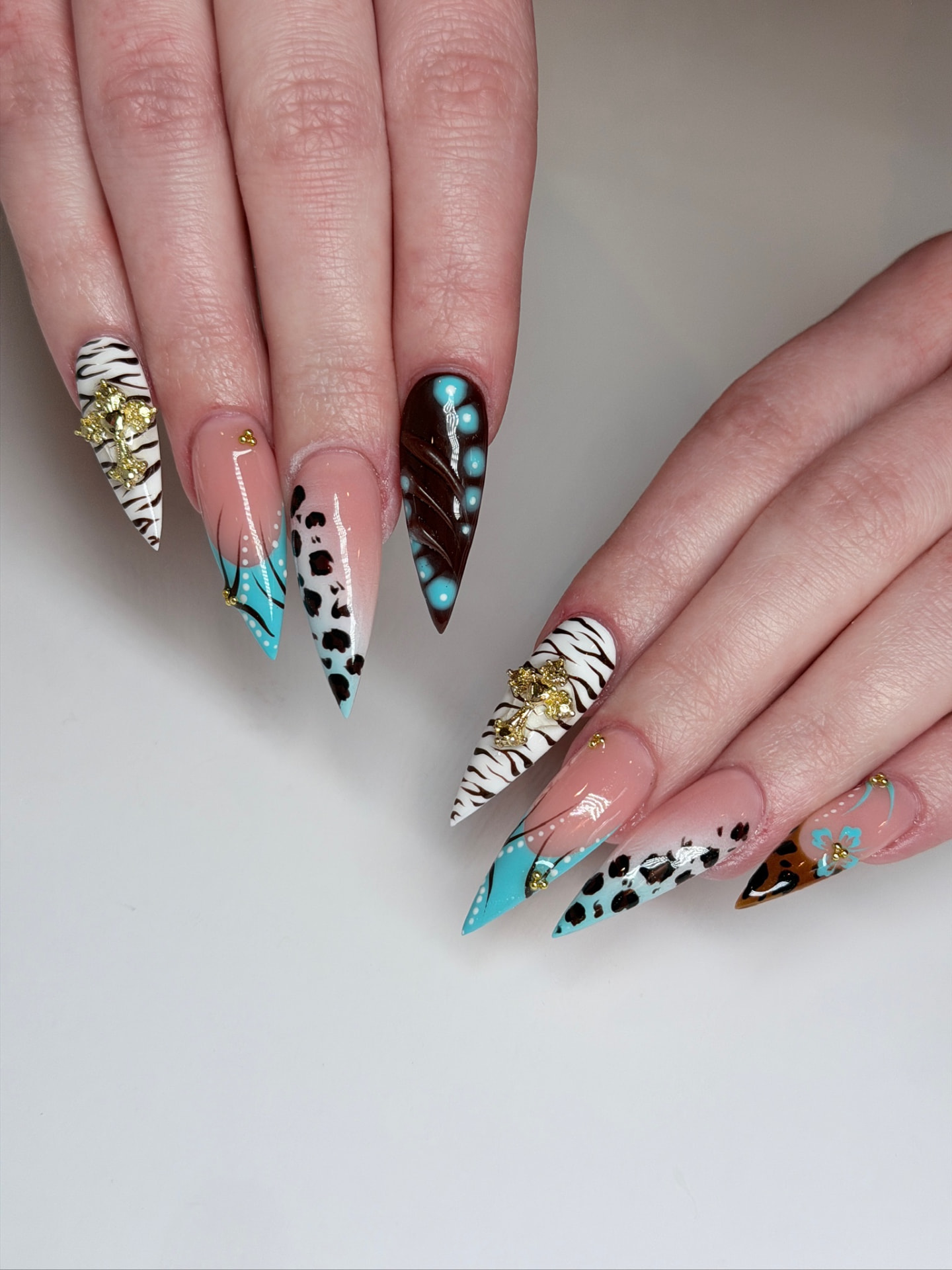 Blume Nail Bar - Luxury Nail Salon — long stiletto nails in turquoise, leopard and zebra with gold charms