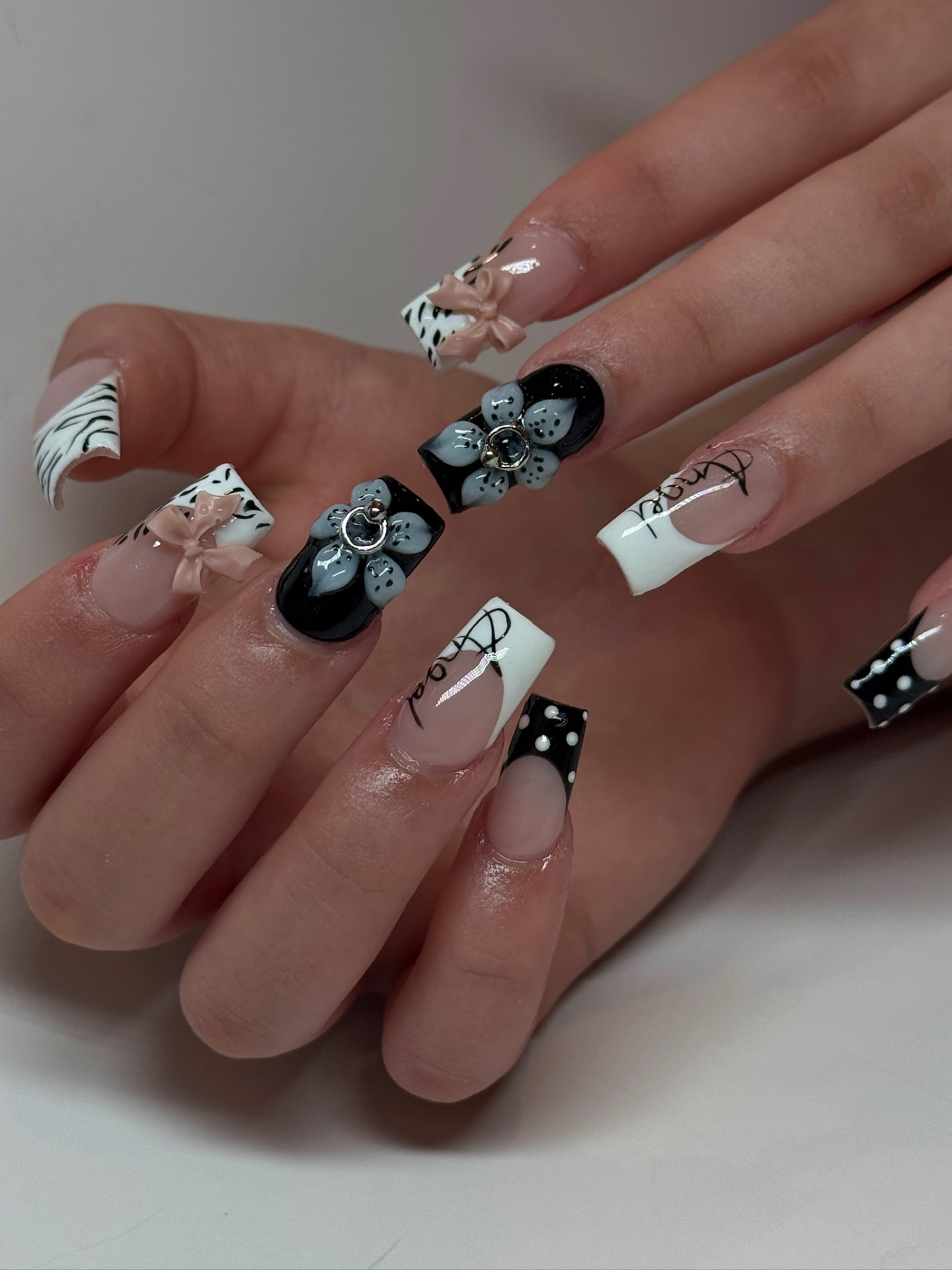 Blume Nail Bar - Luxury Nail Salon — sculpted noir and ivory nails with zebra print, bows and silver charms