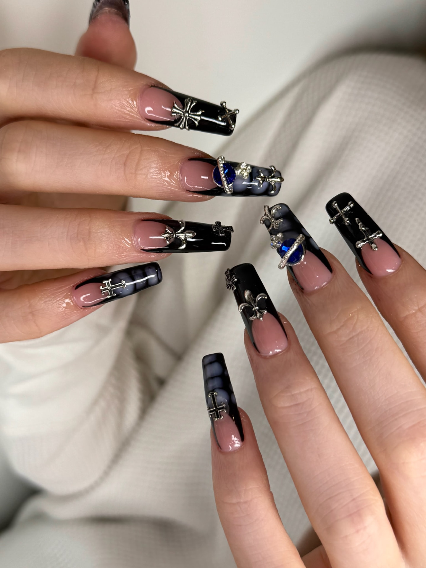 Blume Nail Bar - Luxury Nail Salon — long nails in black marble with silver cross charms and blue gems