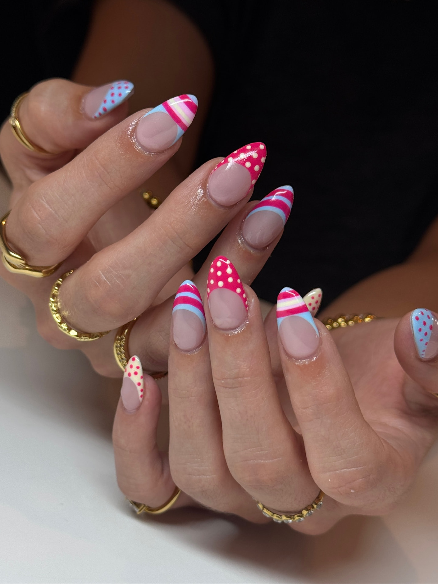 Blume Nail Bar - Luxury Nail Salon — almond nails with cherry-red polka dots, stripes and pastel accents
