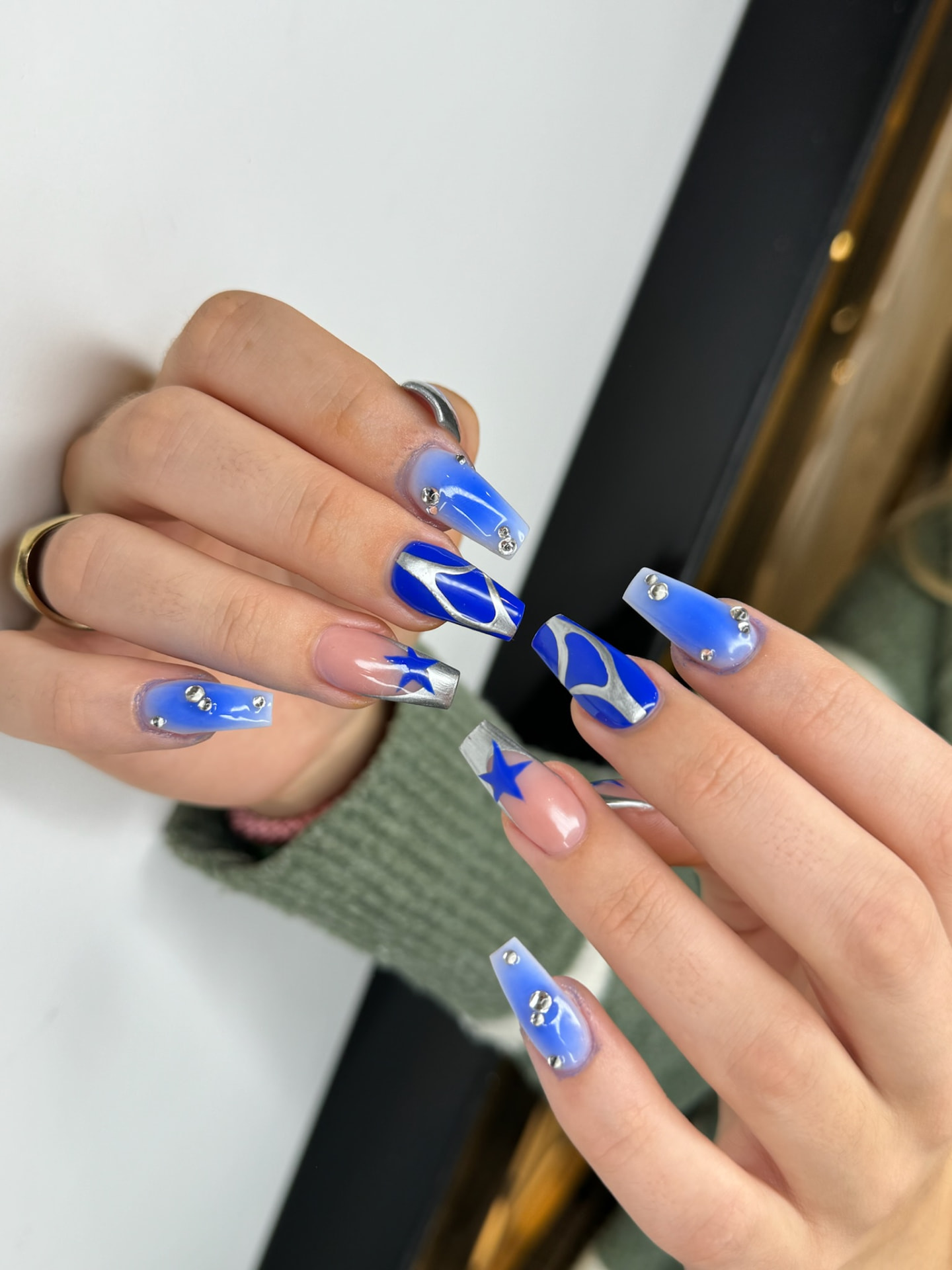 Blume Nail Bar - Luxury Nail Salon — long coffin nails in electric blue chrome with silver star art and gems